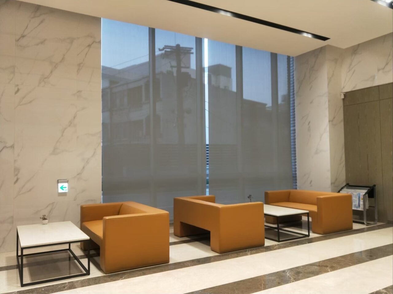 公共空間大面窗，尤其是大樓接待大廳，挑高大窗最大問題就是陽光日照強、面積大會大幅提高窗簾成本，因此捲簾成為經濟與實用上最佳選擇